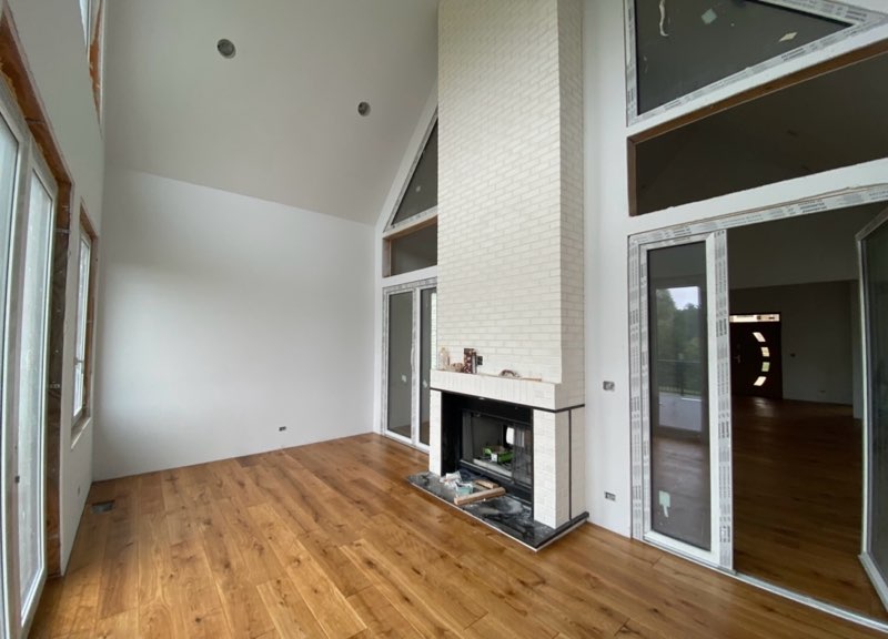 Custom white brick fireplace in vaulted great room